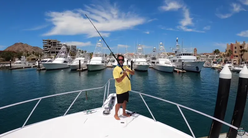 Captain Dave Hansen sharing fishing expertise from a boat in Cabo harbor